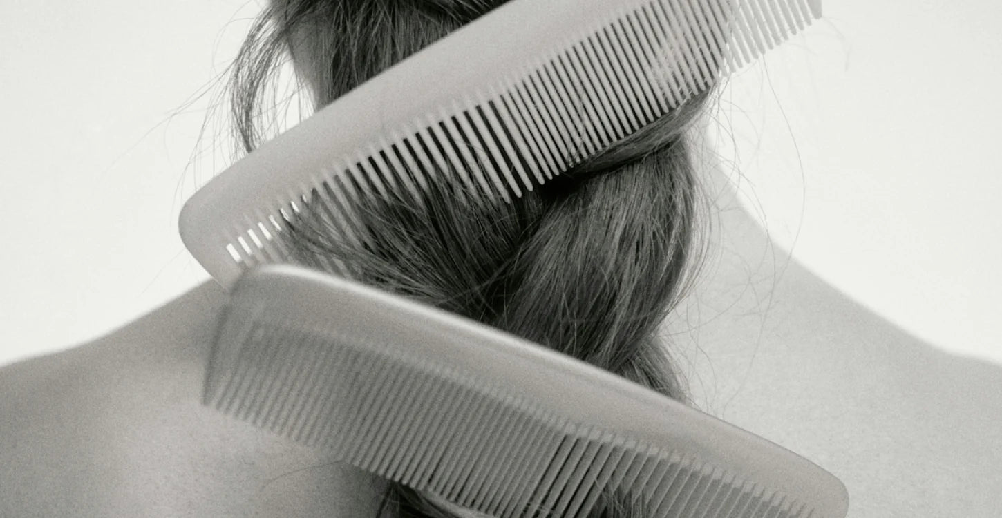 black and white image of a combs stuck on the hair. 