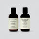 Two bottles of 'Under Your Skin' shampoo and conditioner on a light gray background