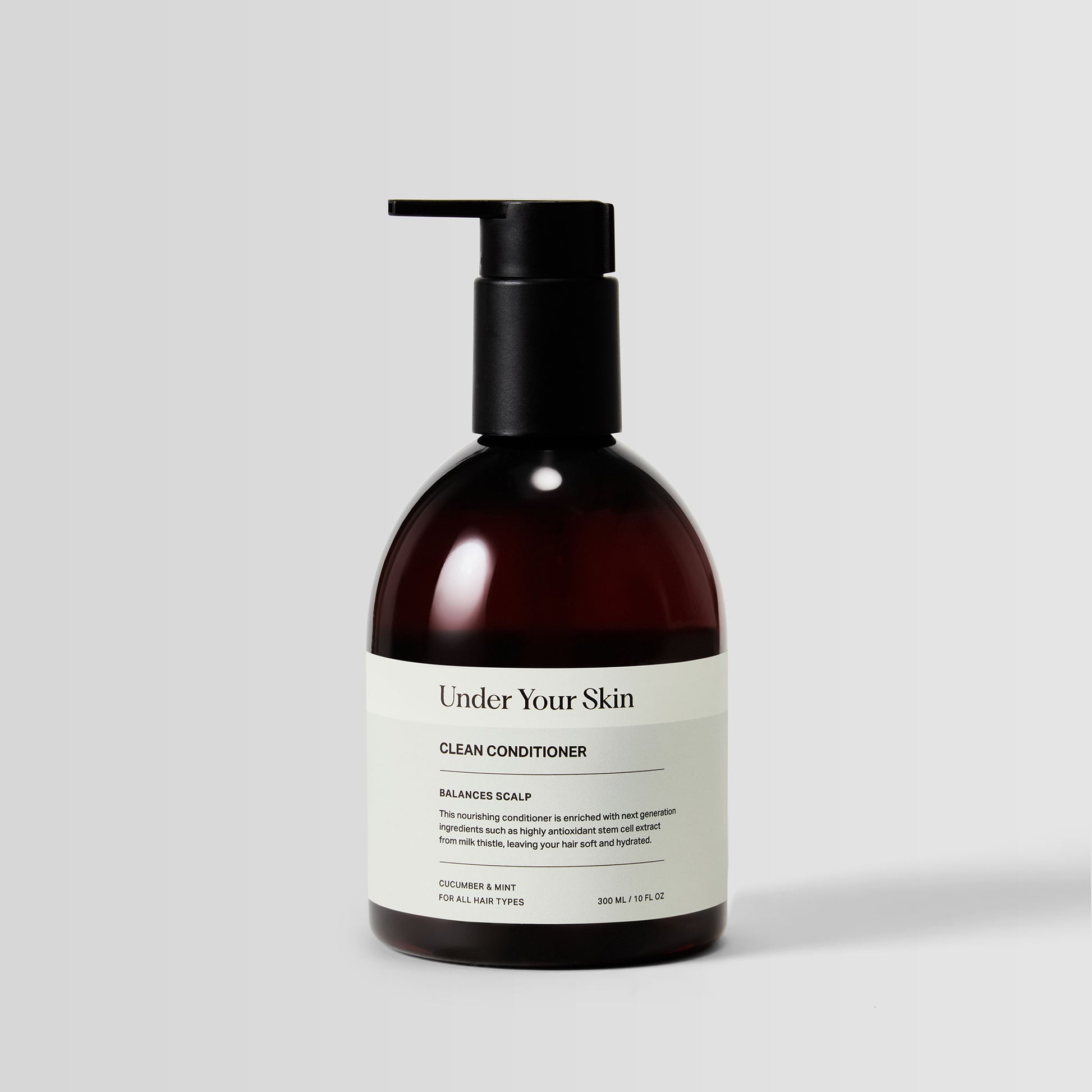 Under Your Skin Detox Clean Conditioner in a 300ml/10 oz brown bottle with pump. Clarifies hair for hydration and softness without silicones. 