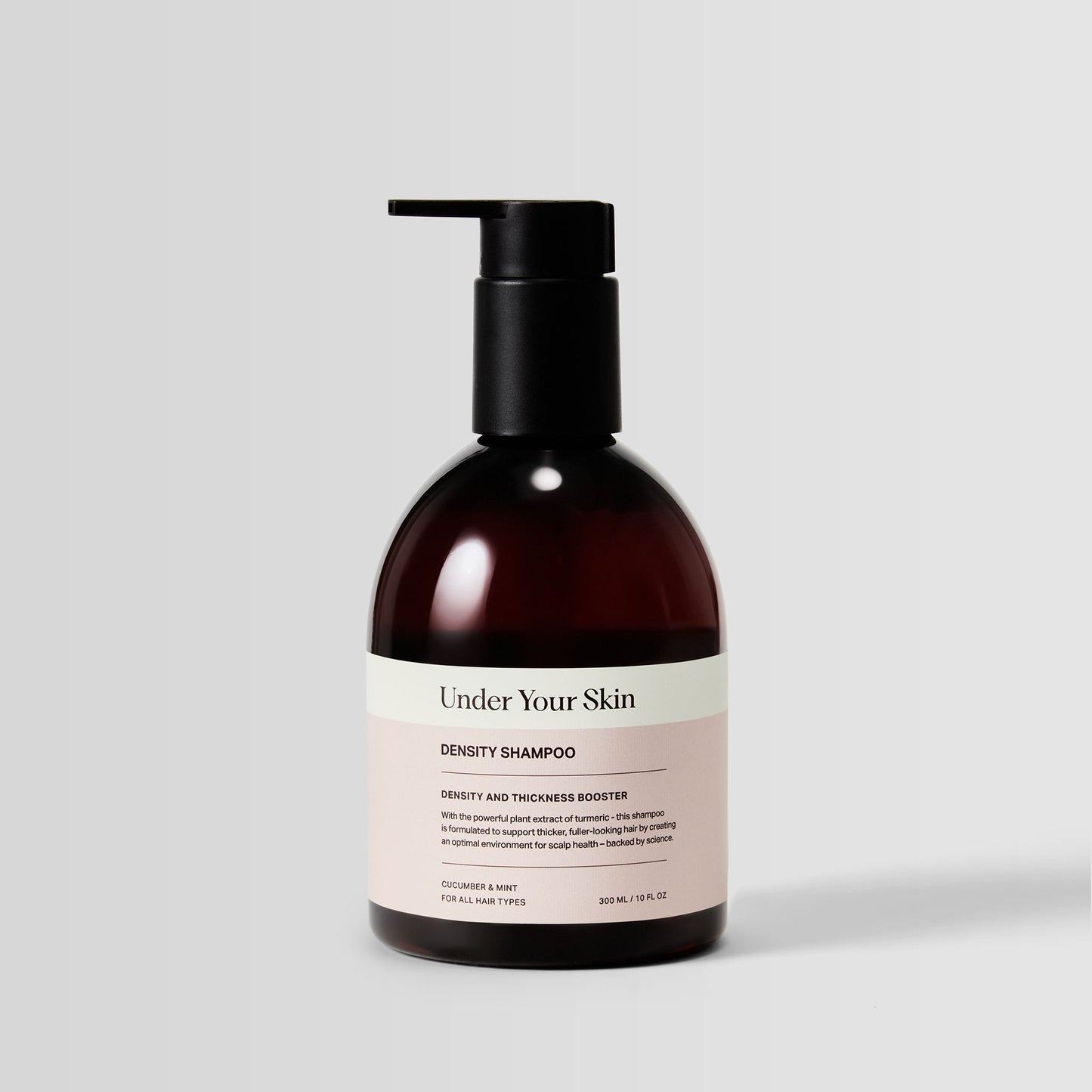 Under Your Skin Density Shampoo in 300ml/10 oz brown bottle with pump. For hair strengthening and volume boost using turmeric extract. 