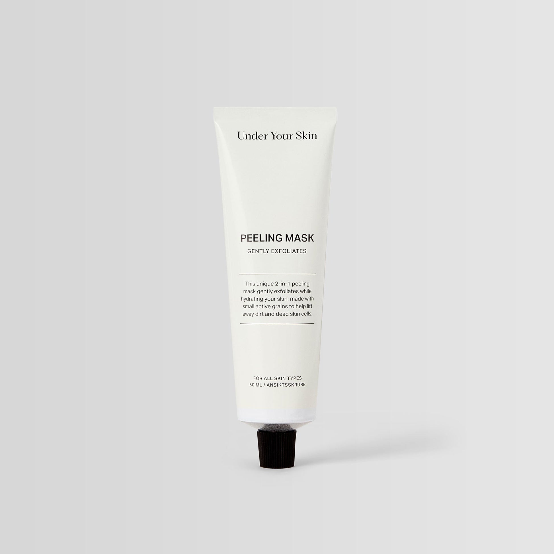 Under Your Skin 2 in 1 Peeling Mask in a 50ml white aluminum tube. Gently exfoliates and hydrates using sea sand.