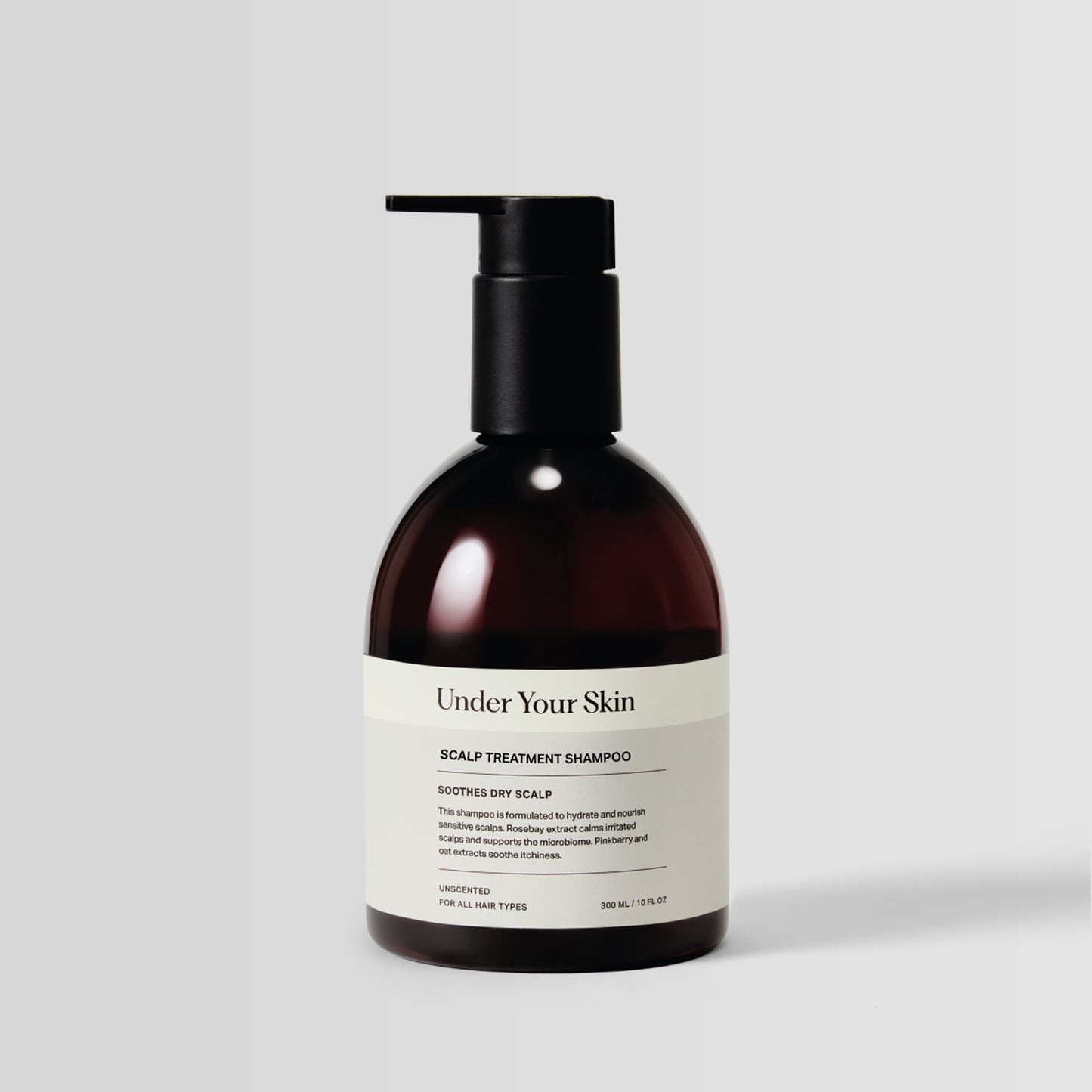 Under Your Skin Soothing Scalp Treatment Shampoo in a 300ml/10 oz brown bottle with pump. Gently cleanses and calms scalp using pinkberry and oat extract. 