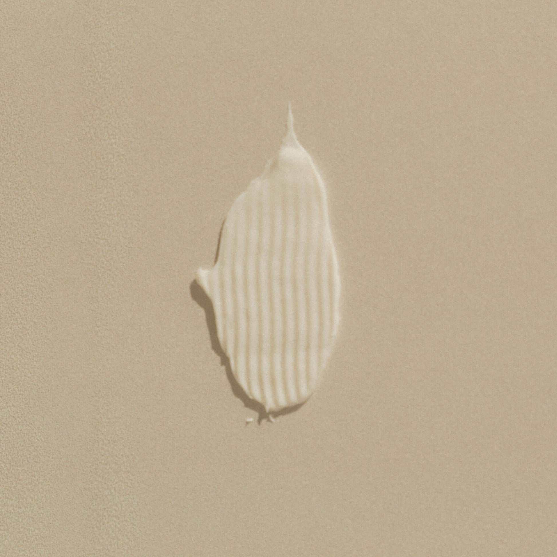 Balsamtest som visar textur på beige bakgrund.