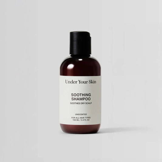 Bottle of 'Under Your Skin' soothing shampoo on a light gray background